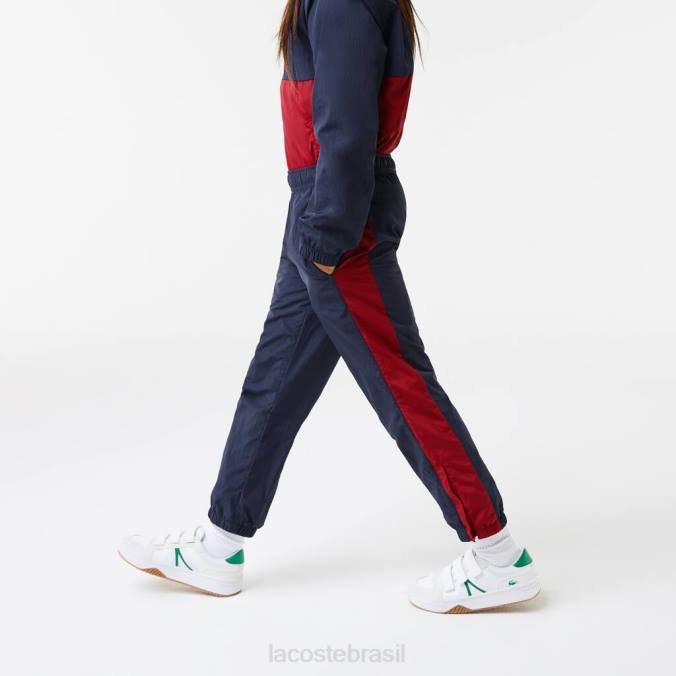 Lacoste crianças calças de treino com banda de contraste azul marinho/bordéu P2PX3225 roupas